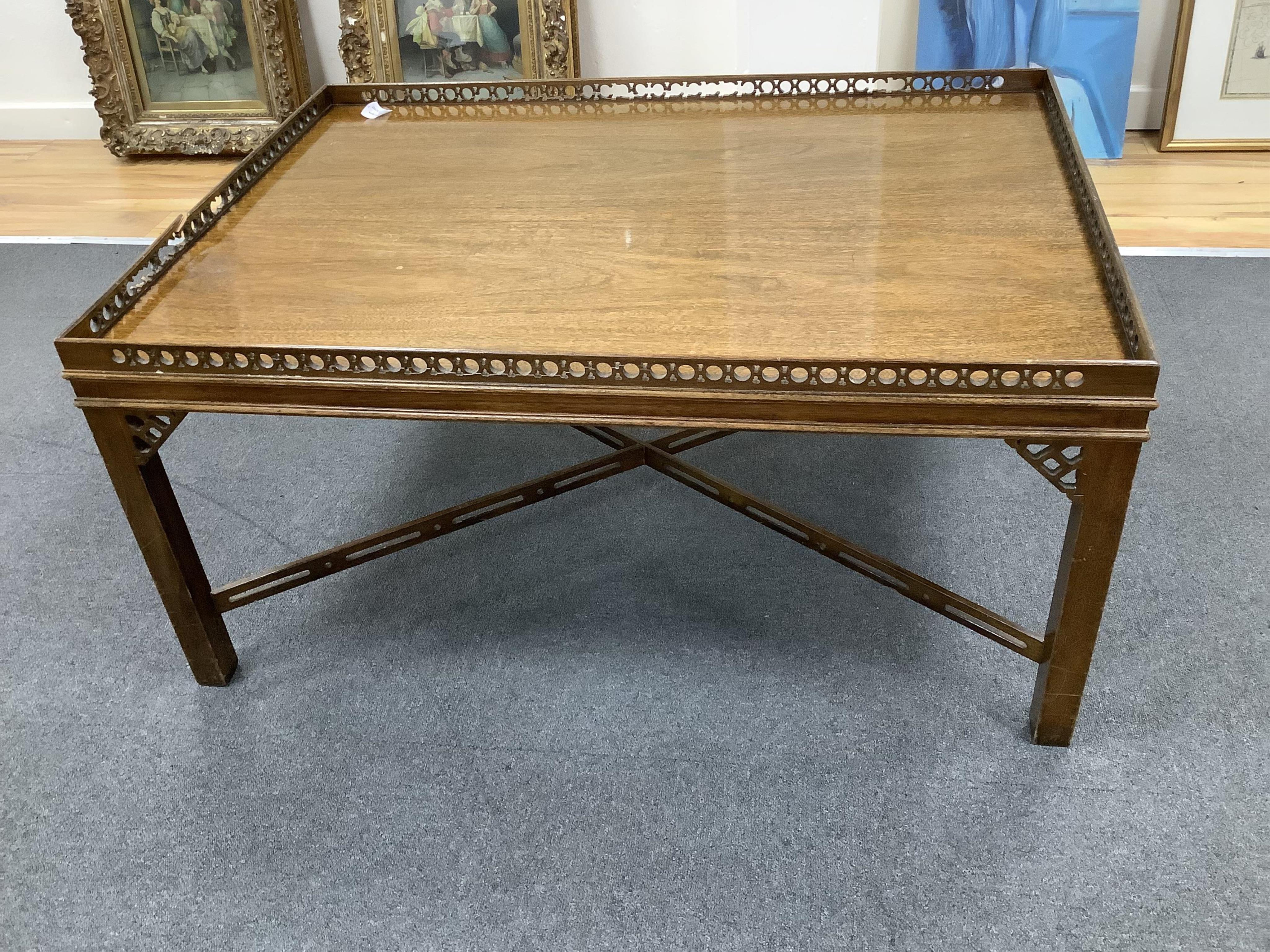 A reproduction George III style rectangular mahogany coffee table, width 106cm, depth 76cm, height 52cm. Condition - poor, fret gallery damaged in several places